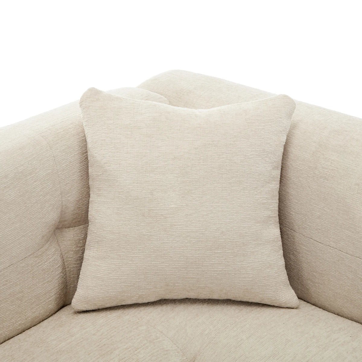 Canapé d’angle modulable beige avec repose-pieds, détail du coussin