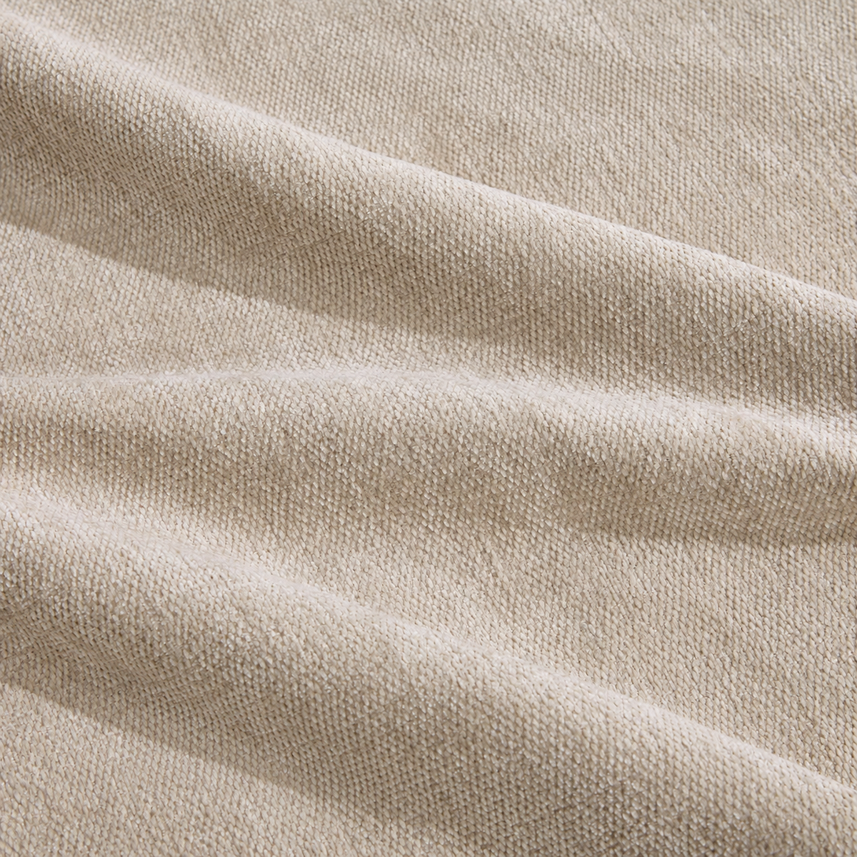 Canapé modulable beige avec deux poufs, détail du tissu beige