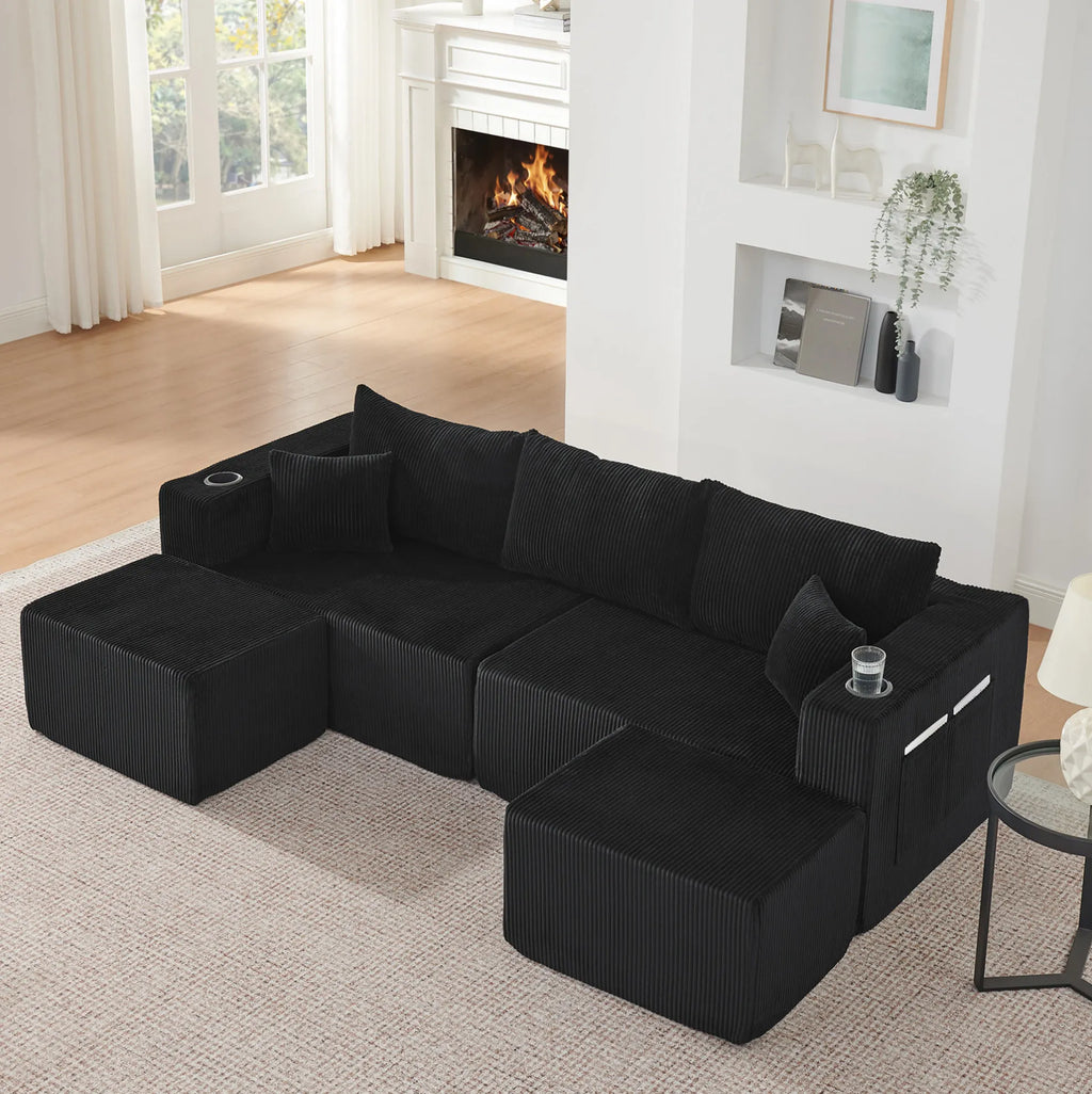 Canapé modulaire noir en velours côtelé à poufs mobiles, vue de dessus en situation