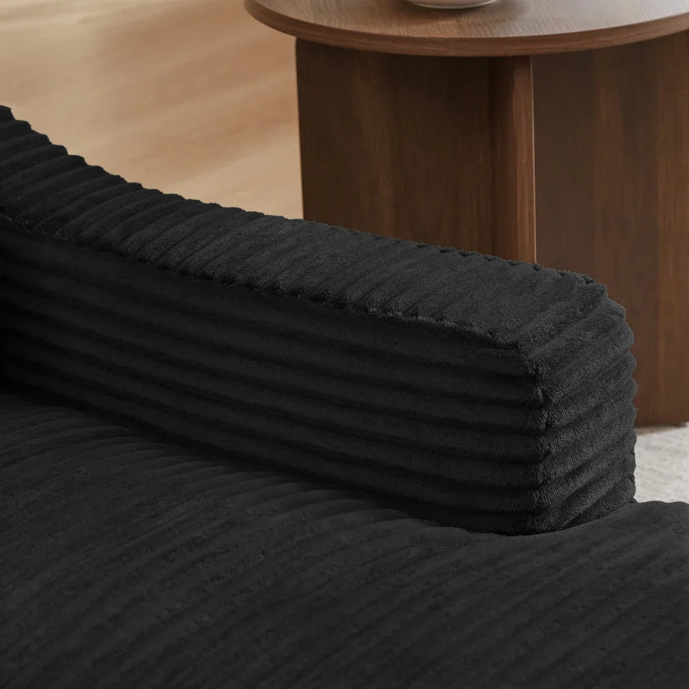 Fauteuil et repose-pieds modulables en velours côtelé noir, détail de l’accoudoir et du tissu