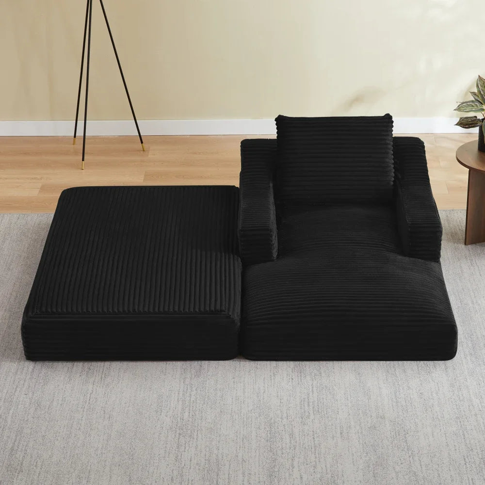 Fauteuil et repose-pieds modulables en velours côtelé noir, modules disposés côte à côte avec assise déployée